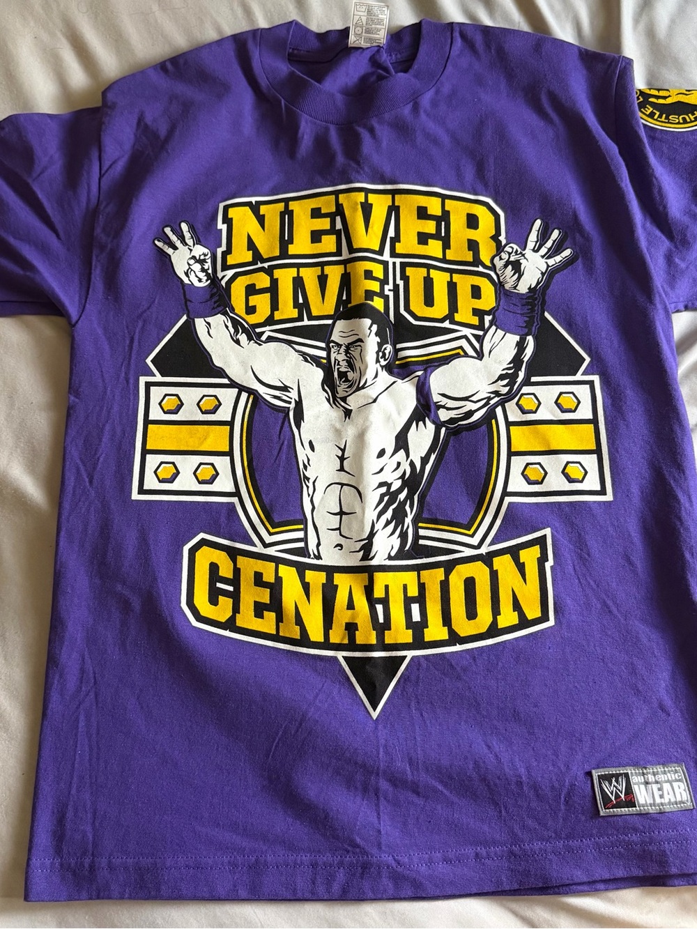 WWE Purple Cenation "Never Give Up" Graphic Tee with Yellow Accents